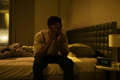 man lying awake at night unable to sleep due to overthinking