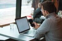 person distracted at desk avoiding work showing the struggle of how to stop procrastinating