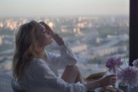 person looking out window searching for direction showing the journey of how to find a purpose in life