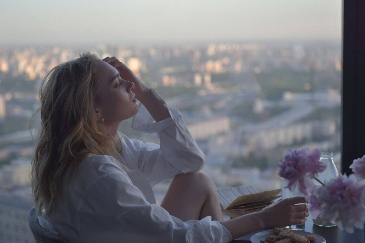 person looking out window searching for direction showing the journey of how to find a purpose in life