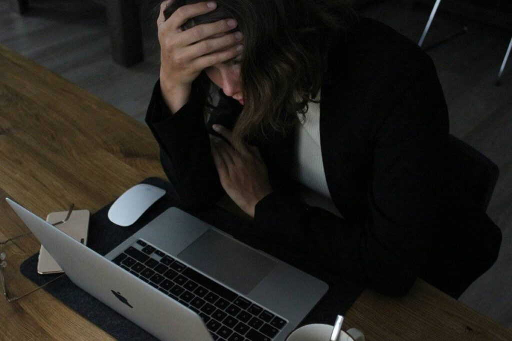 person frustrated and guilty showing the weight of avoidance when learning how to stop procrastinating