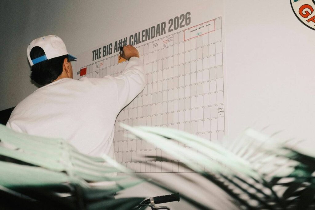 person marking habit tracker showing a key step in learning how to be more disciplined