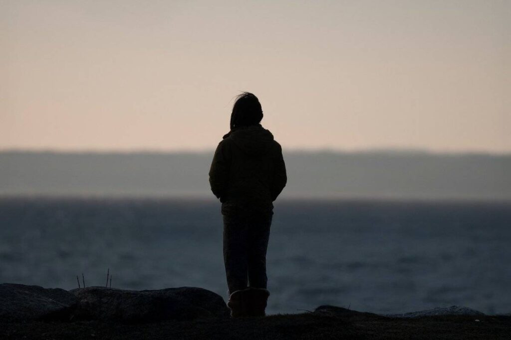 person standing in morning light calm and hopeful after learning how to deal with heartbreak