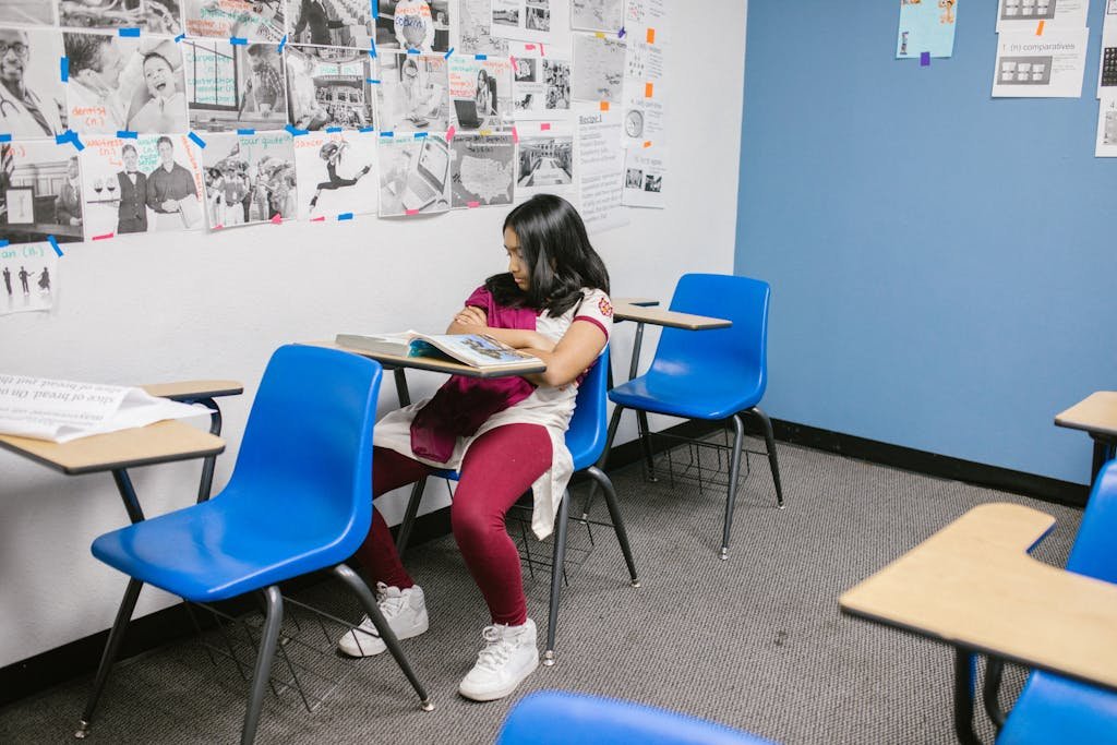 A Girl Sitting Lonely by Herself in the Classroom