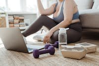 A Woman in Blue Tank Top Sitting on the Floor