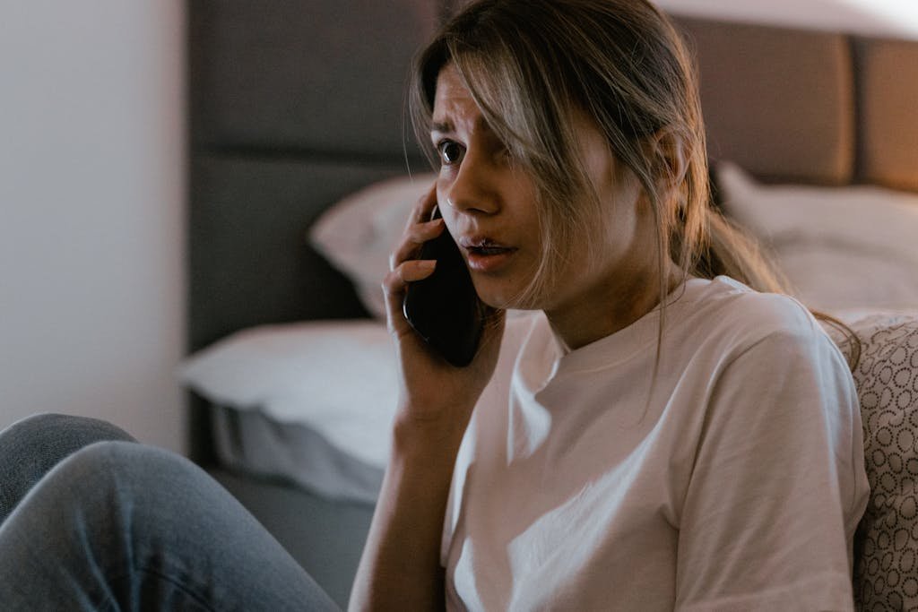 A Woman in White Shirt Calling on Her Cellphone