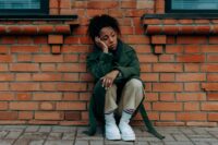 person sitting alone feeling the pain of rejection and learning how to deal with rejection