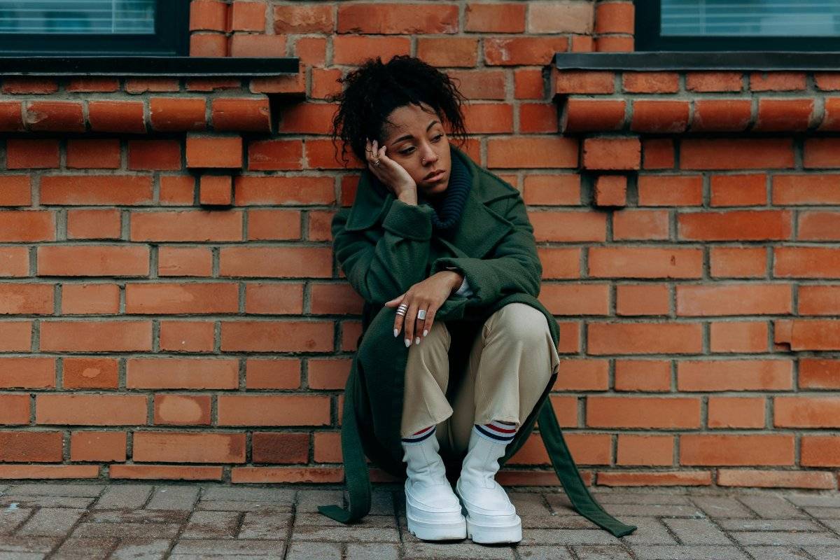 person sitting alone feeling the pain of rejection and learning how to deal with rejection