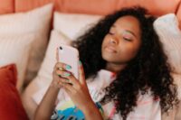 person scrolling phone feeling the pain of comparing yourself to others on social media