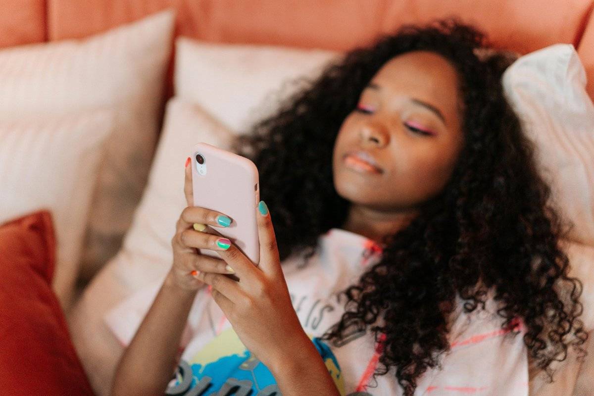 person scrolling phone feeling the pain of comparing yourself to others on social media