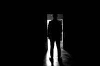 person hesitating at doorway showing the struggle of how to overcome fear