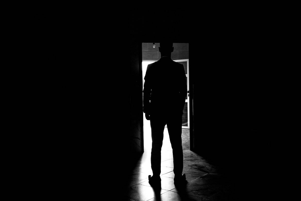person hesitating at doorway showing the struggle of how to overcome fear