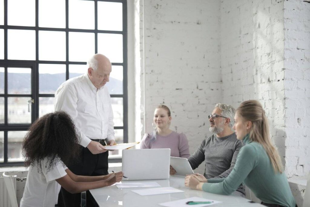 person speaking confidently in group after learning how to build self confidence