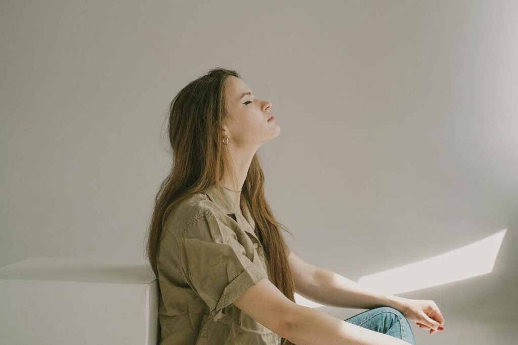 person sitting peacefully practicing self compassion exercises and mindfulness