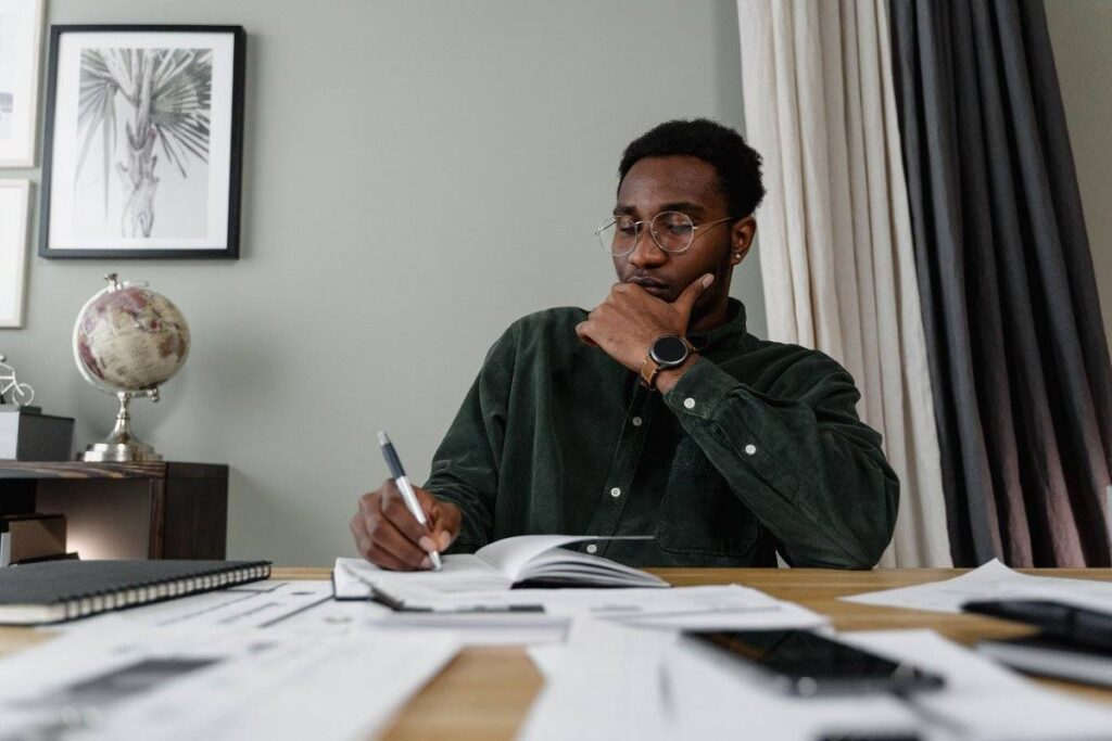person writing in notebook separating facts from stories after rejection