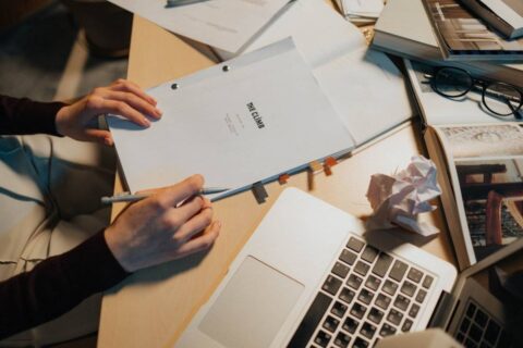 person overwhelmed at cluttered desk struggling with how to be more productive
