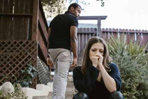 couple sitting apart showing broken trust in a relationship