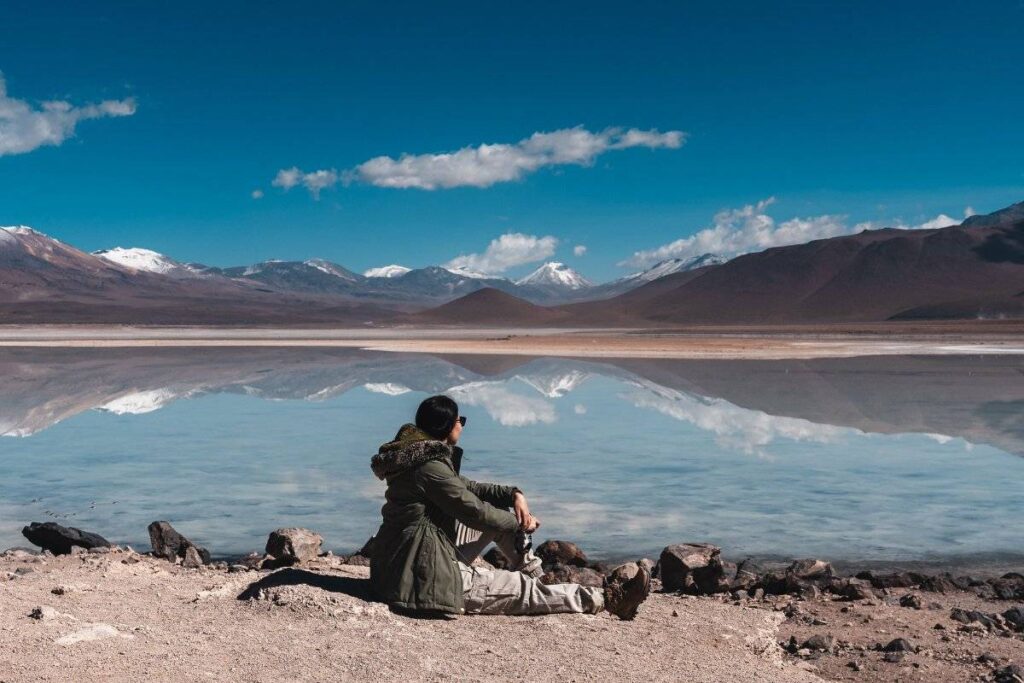 person sitting outdoors reflecting quietly on how to practice gratitude daily