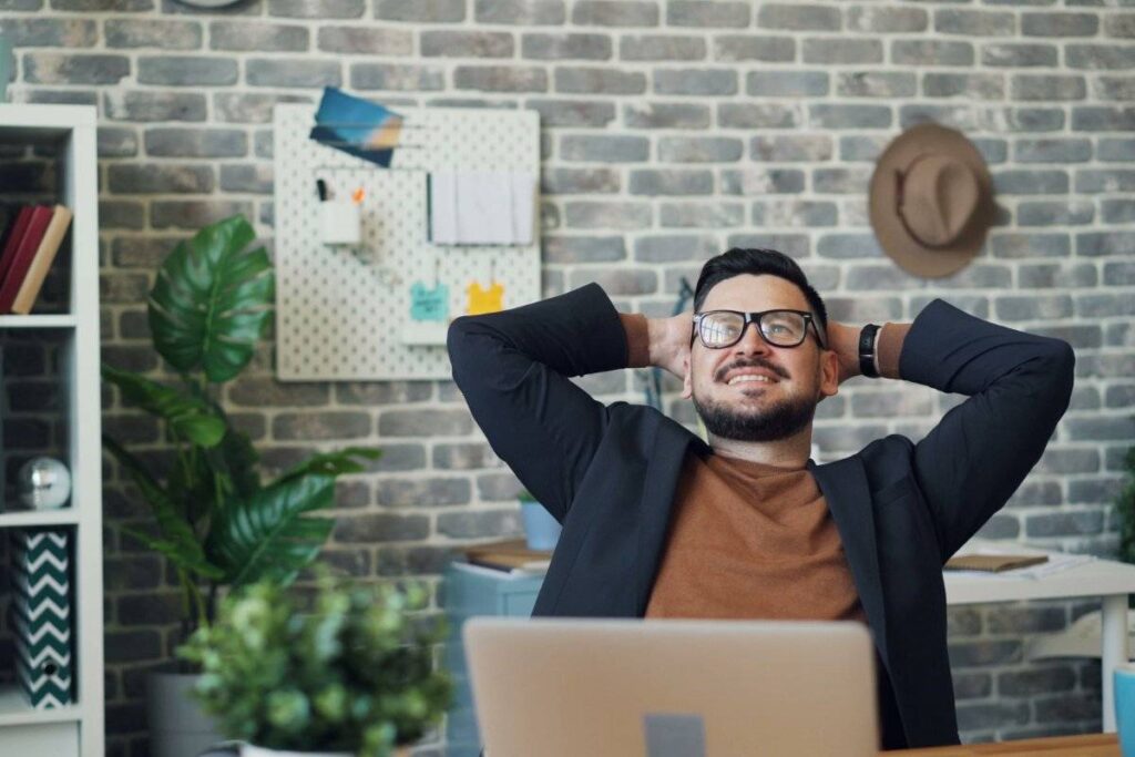 person quietly satisfied after meaningful work showing results of how to be more productive
