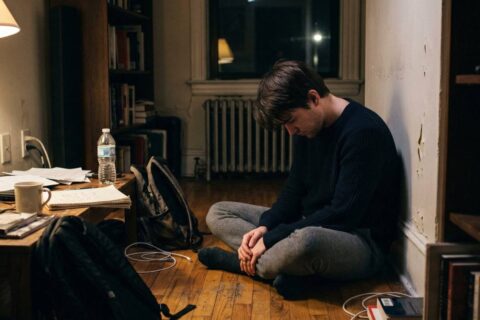 person sitting alone feeling the weight of failure and learning how to deal with failure