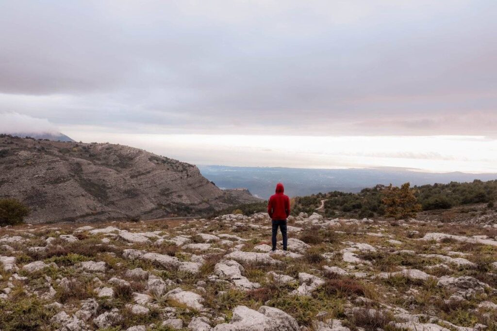 person standing tall and grounded outdoors after learning how to be more confident