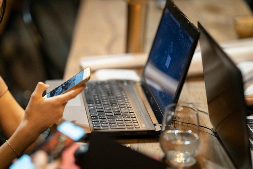 person distracted by phone showing the difference between busy and how to be more productive