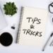 Productivity tips workspace with coffee, notebook, and glasses on desk