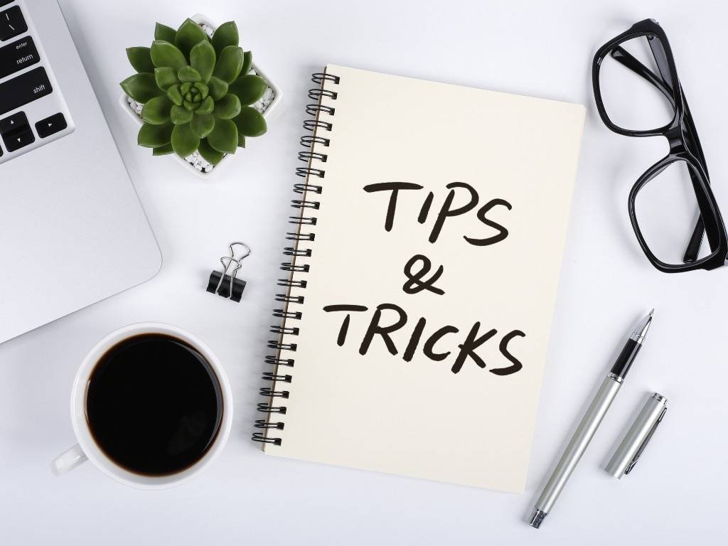 Productivity tips workspace with coffee, notebook, and glasses on desk