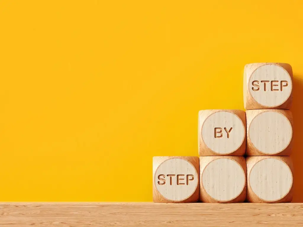 Step by step wooden blocks symbolizing gradual progress and personal growth