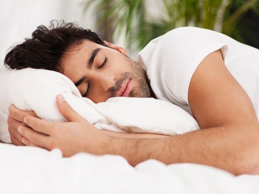 Man sleeping peacefully on pillow, showing connection between quality sleep and mental health