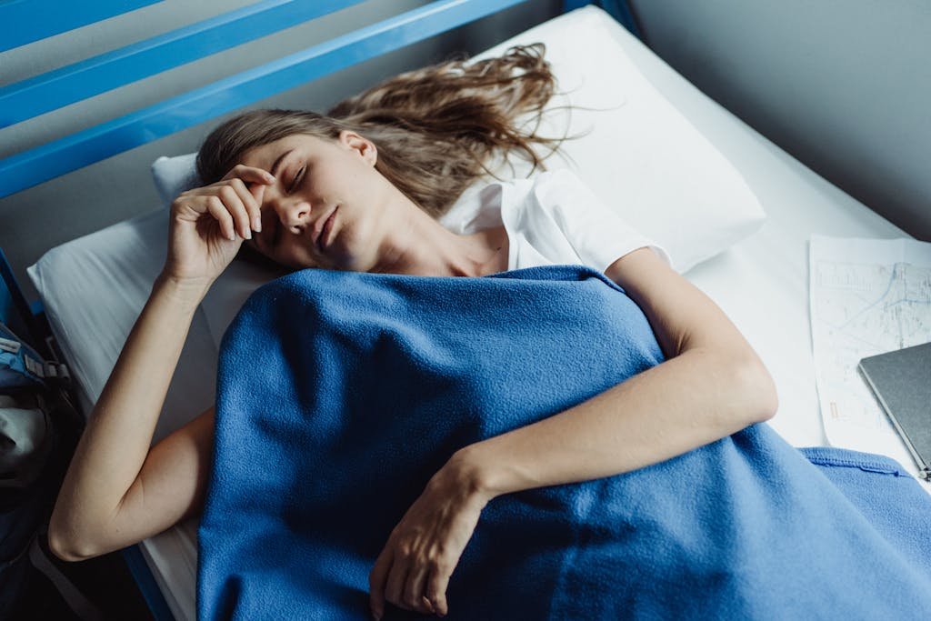 Woman Sleeping Under a Blue Blanket 