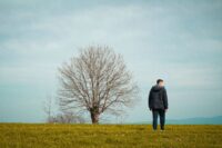 person standing alone calm and self-possessed showing the quiet freedom of learning how to stop caring what people think