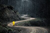 person looking at winding mountain path showing the honest shape of how to grow as a person