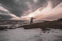 person standing steady through difficulty showing the honest reality of how to build resilience