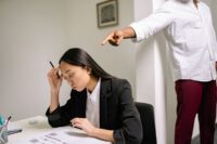 two people in tense office setting showing the discomfort of needing to learn how to deal with a difficult coworker