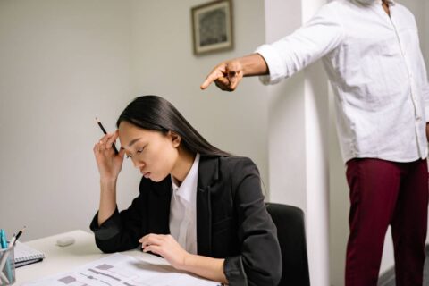two people in tense office setting showing the discomfort of needing to learn how to deal with a difficult coworker