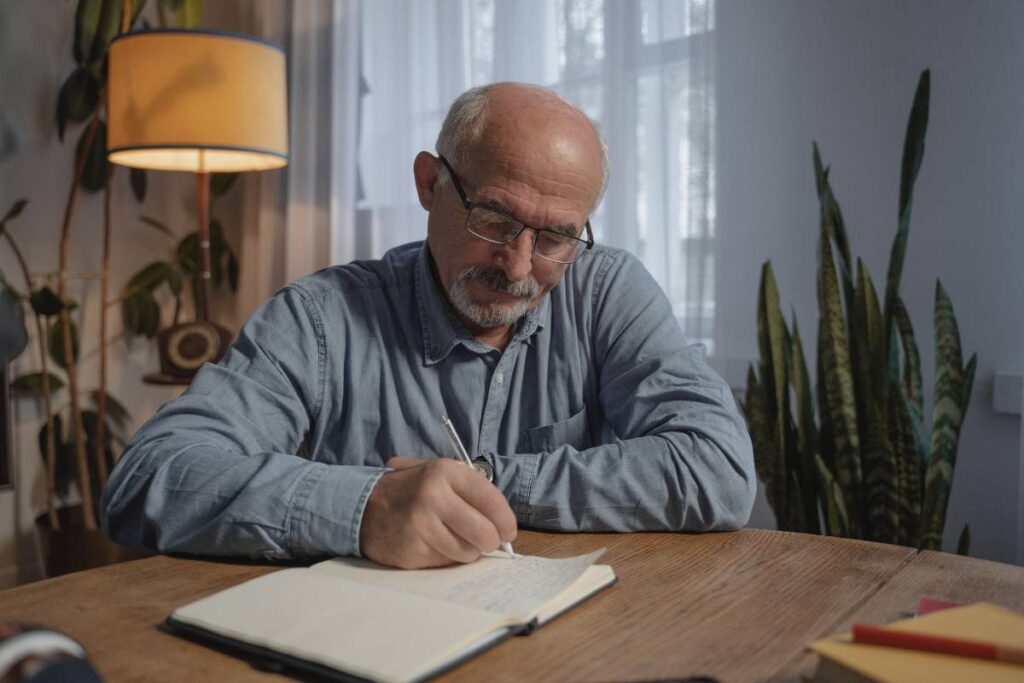 person writing honestly in journal documenting progress while learning how to grow as a person