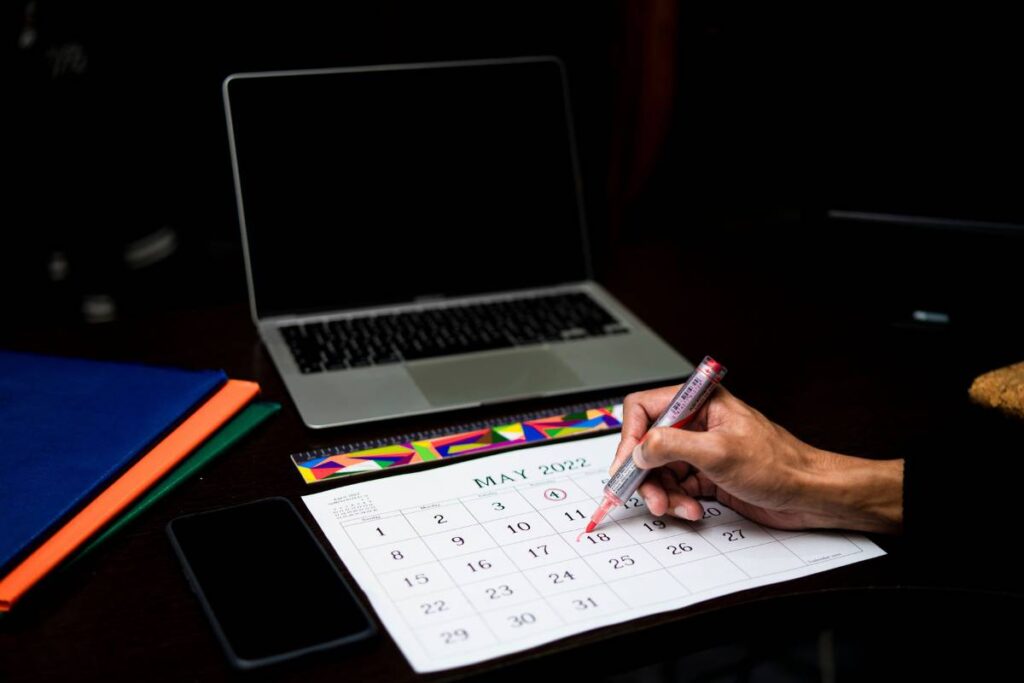 person marking habit tracker showing the patient daily work of learning how to build good habits