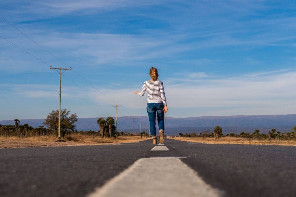 person taking a different path showing a small change that helps how to get out of a rut