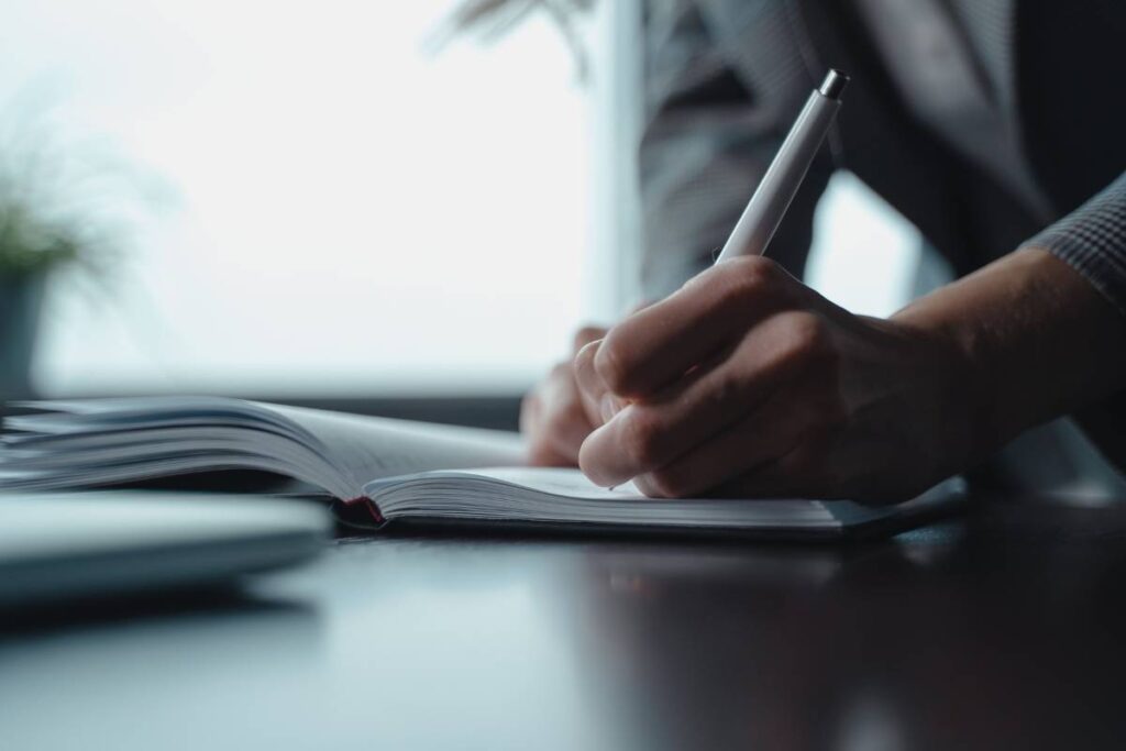 person writing documentation calmly showing professional control in how to deal with a difficult coworker