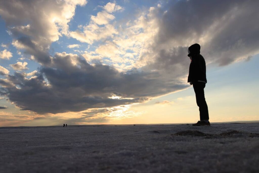 person standing calm and steady after difficulty showing the result of learning how to build resilience
