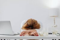 person completely depleted at desk showing the honest reality of needing to learn how to deal with burnout