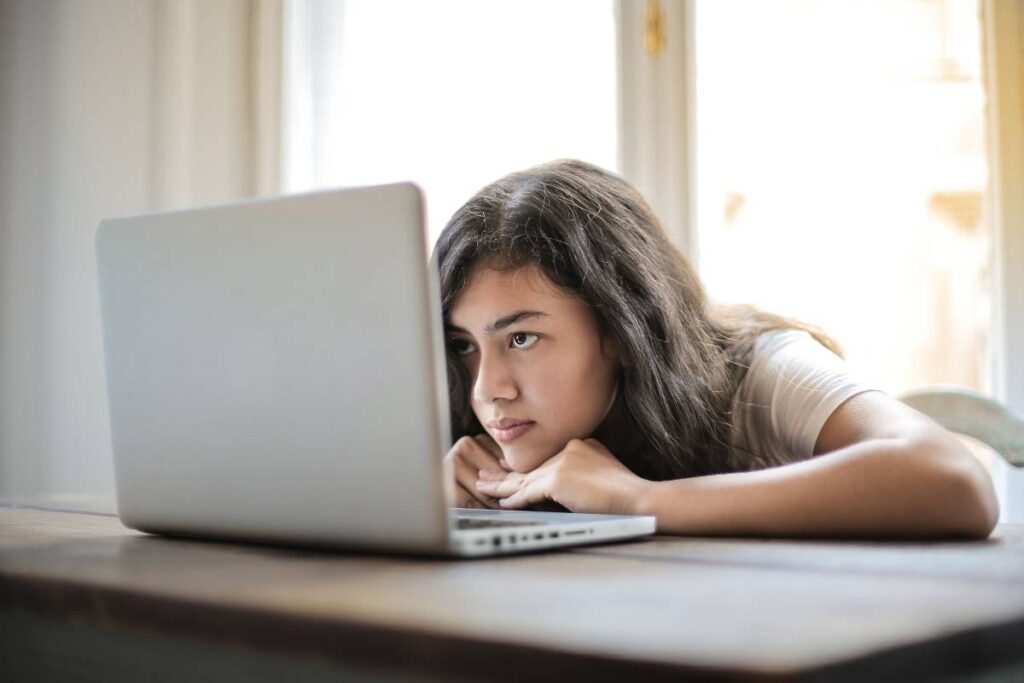 person staring blankly at screen showing the middle stage described in how to deal with burnout