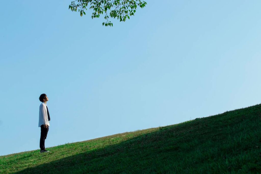 person standing calm and grounded showing the stability possible when learning how to be less sensitive