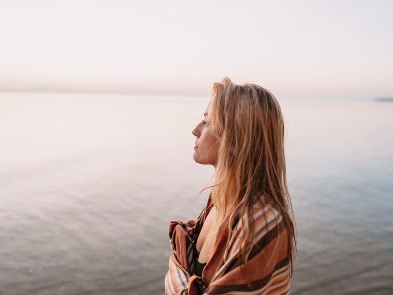 Woman practicing mindfulness by the sea – mindfulness practices for inner peace