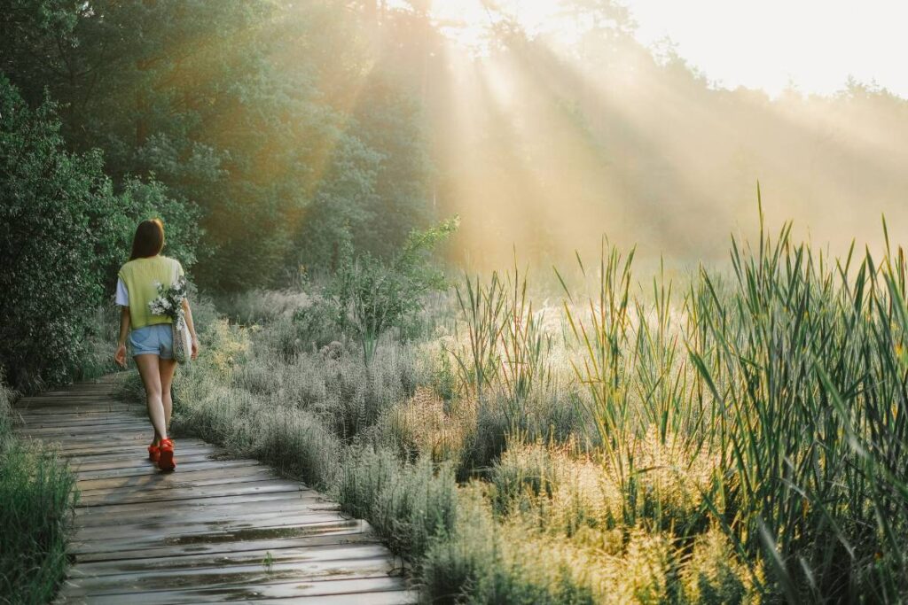 person on gentle walk outdoors showing the physical recovery needed when learning how to deal with burnout
