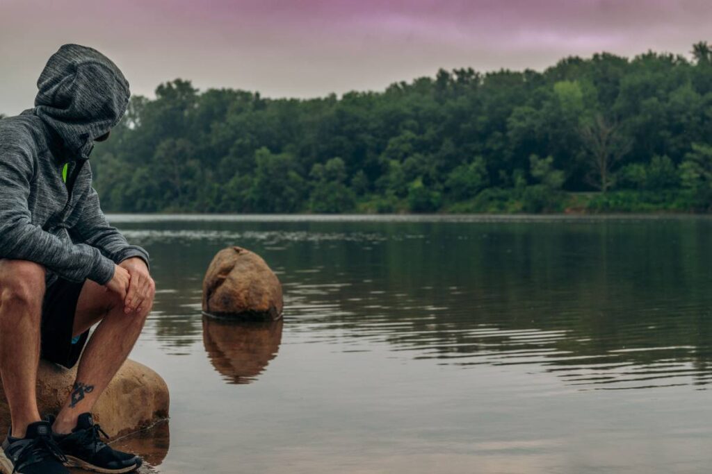 person sitting peacefully calm showing the earned recovery that comes from learning how to deal with burnout