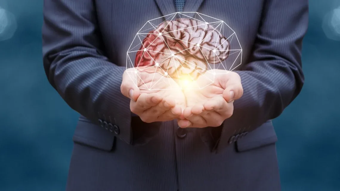 Positive mindset concept illustrated with a glowing brain in hands, symbolizing mental health, growth, and emotional well-being.