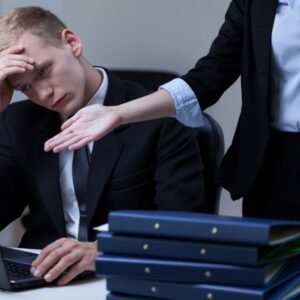 Stressed businessman receiving harsh criticism from a manager in the workplace