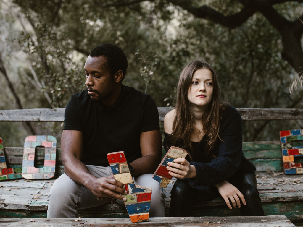 Couple sitting apart showing emotional distance – impact of emotional relationships on mental health